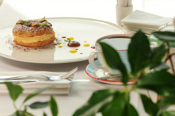 dessert cake donuts in a white plate on the table with tea close-up
