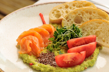 guacamole with shrimp and tomatoes in a plate
