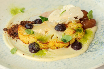 baked cauliflower with cheese and sauce in a plate
