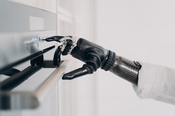 Oven opening with cyber arm prosthesis grasp. Disabled person amputee going to cook.