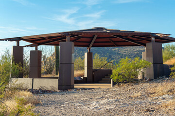 Fototapeta na wymiar Concreate gazebo with tin metal roof in national park or in rural campground in a wilderness or forest area