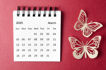 The March 2023 desk calendar for the organizer to plan and reminder with paer butterfly on red background.