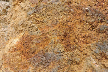 A brown and orange sedimentary rock containing sulfur and pyrite