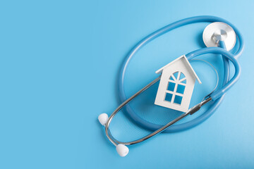 home doctor, medical clinic with home visits, ambulance, house and medical stethoscope on blue...
