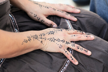 Henna, one of the eastern traditions. Henna patterned on a woman's hand.. Close up of a person...