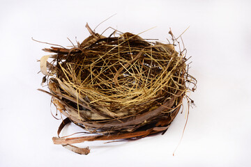 Obraz premium original bird's nest. A real bird's nest made by a bird from dried plant parts. on a white background.