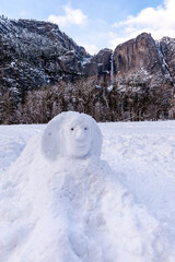 Obraz na płótnie Canvas Exterior of a snowman resembling the Sfinx, in yosemite valley, with the famous falls in the background.