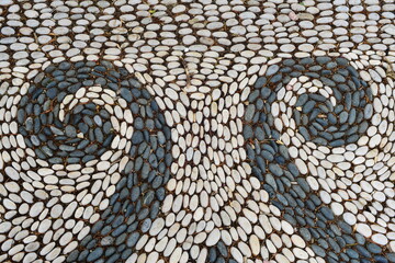 Mosaic stones, a floral floor decoration pattern made of pebbles.