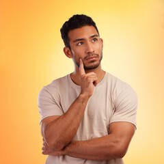 Thinking, wondering and thoughtful Asian man with a choice isolated on a yellow background in a...
