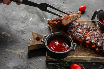 Spicy rack of spare ribs with marinade on a dark background. banner, menu, recipe place for text,...