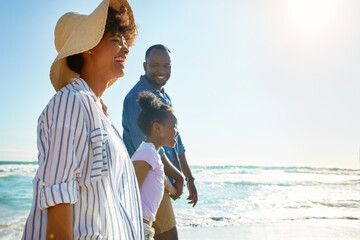 Family, travel and walking on a beach with a child or kid on vacation at the ocean or sea. Mock up, parents and happy African American daughter relaxing and enjoying trip or holiday and holding hands