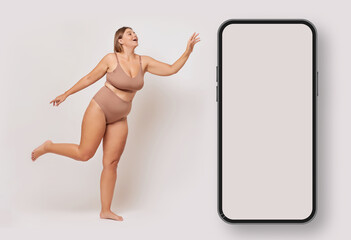 Positive body concept. Charming young woman wearing basic underwear, flying in the air and reaching...