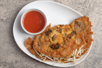 Fried mussels in crispy batter in a white plate