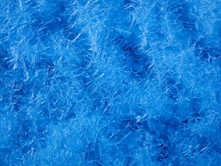 Close up of dark blue frosty pattern on ice