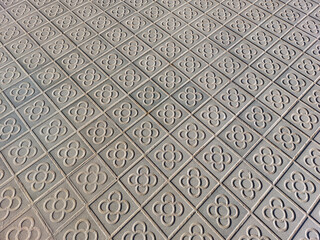 Pavement in Barcelona made of small tiles with the traditional pattern 