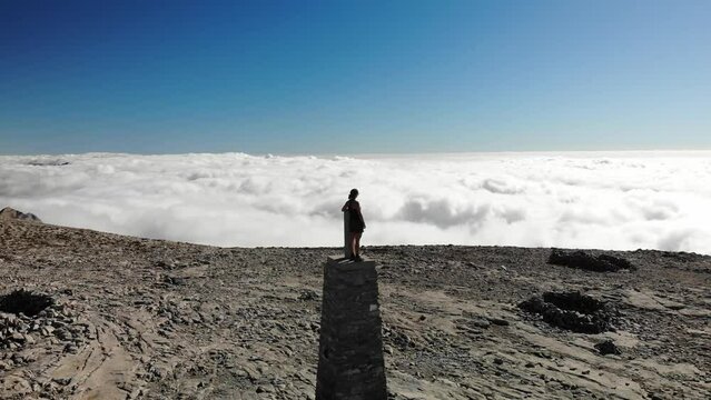 4K drone footage over woman on the summit of a rocky peak overlooking breathtaking sea of clouds at La Maroma summit, Malaga, Spain.
Mid angle, parallax movement.