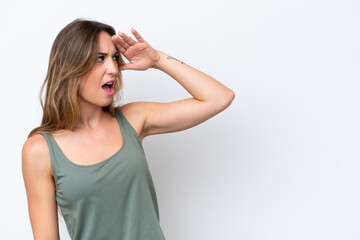 Fototapeta premium Young caucasian woman isolated on white background with surprise expression while looking side