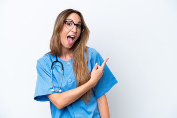 Young surgeon doctor woman isolated on blue background surprised and pointing side