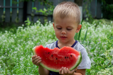 A child eats watermelon. Selective focus.