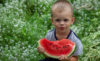 A child eats watermelon. Selective focus.