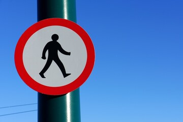 UK road sign. No entry for pedestrians. Blue sky