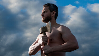 shirtless guy with axe. caucasian guy hold ax. brutal guy on sky background