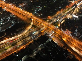 Fototapeta na wymiar Aerial view of car traffic transportation above circle road of Drone aerial view fly , high angle. Public transport or commuter city life concept of economic and energy, infrastructure 