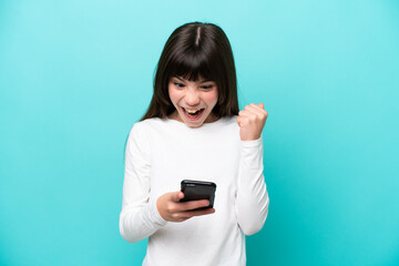 Little caucasian girl isolated on blue background surprised and sending a message