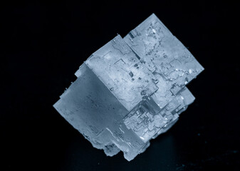 Salt crystal on a black background microscope view