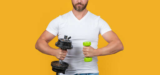 cropped strong sport man training with dumbbell isolated on yellow. strong sport man