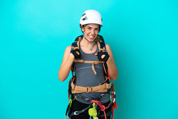 Young Italian rock-climber woman isolated on blue background with surprise facial expression