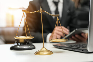 judge on wooden table And experienced lawyers meet with clients and give advice behind the scenes....