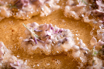 Tasty and homemade fried lilac flower with powdered sugar.