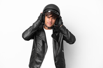 Young man with a motorcycle helmet isolated on white background frustrated and covering ears