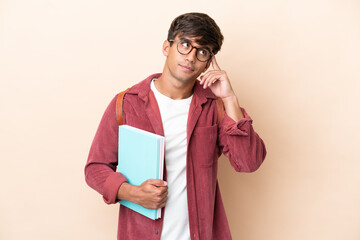 Young student caucasian man isolated on ocher background having doubts and thinking