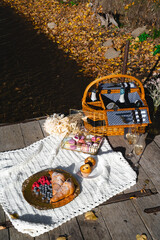 Picnic by the lake during autumn with vibrant foliage and a serene atmosphere