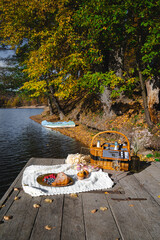Picnic by the lake during autumn with vibrant foliage and a serene atmosphere