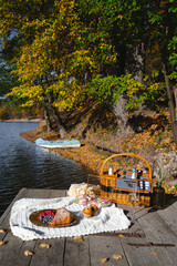 Picnic by the lake during autumn with vibrant foliage and a serene atmosphere