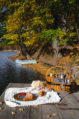 Picnic by the lake during autumn with vibrant foliage and a serene atmosphere