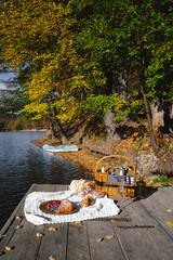 Picnic by the lake during autumn with vibrant foliage and a serene atmosphere