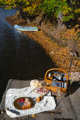 Picnic by the lake during autumn with vibrant foliage and a serene atmosphere