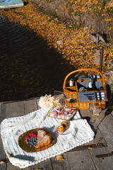 Picnic by the lake during autumn with vibrant foliage and a serene atmosphere