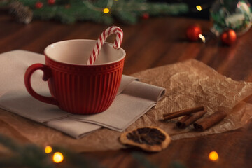 A mug of hot cocoa on a wooden table. Cozy Christmas composition. Decorations in a retro style. The feeling of a holiday. The concept of coziness, good mood and winter holidays.