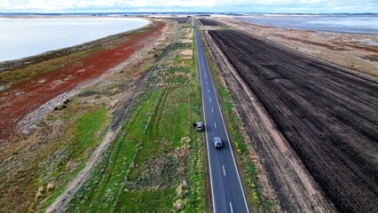Drone shot of  a car on the road at Lake Corangamite, Victoria, Australia 3251