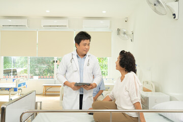 Obraz premium Portrait of Asian doctor check up body of sick old senior elderly patient on bed in hospital in medical and healthcare treatment at nursing home. People lifestyle