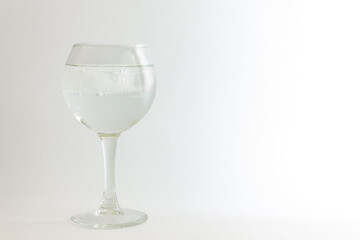 Glass with mineral water on a white background.