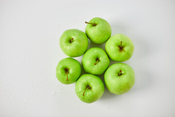 Apple ripe green apples on a white background, harvest fruits concept. Top view