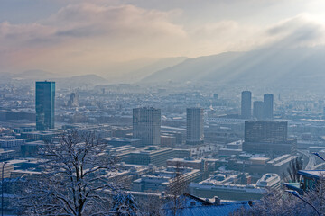 Obraz premium Scenic aerial view over snow covered City of Zürich with skyscraper Prime Tower on a blue cloudy late autumn day. Photo taken December 11th, 2022, Zurich, Switzerland.