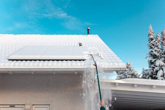 removing snow off solar panels in winter. Removing snow photovoltaic system - solar cells. snow covers panels - no producing power. cleaning solar panels from snow