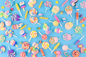 Background of decorative sweets, lollipops and ice cream. Top view on blue background - 563279634